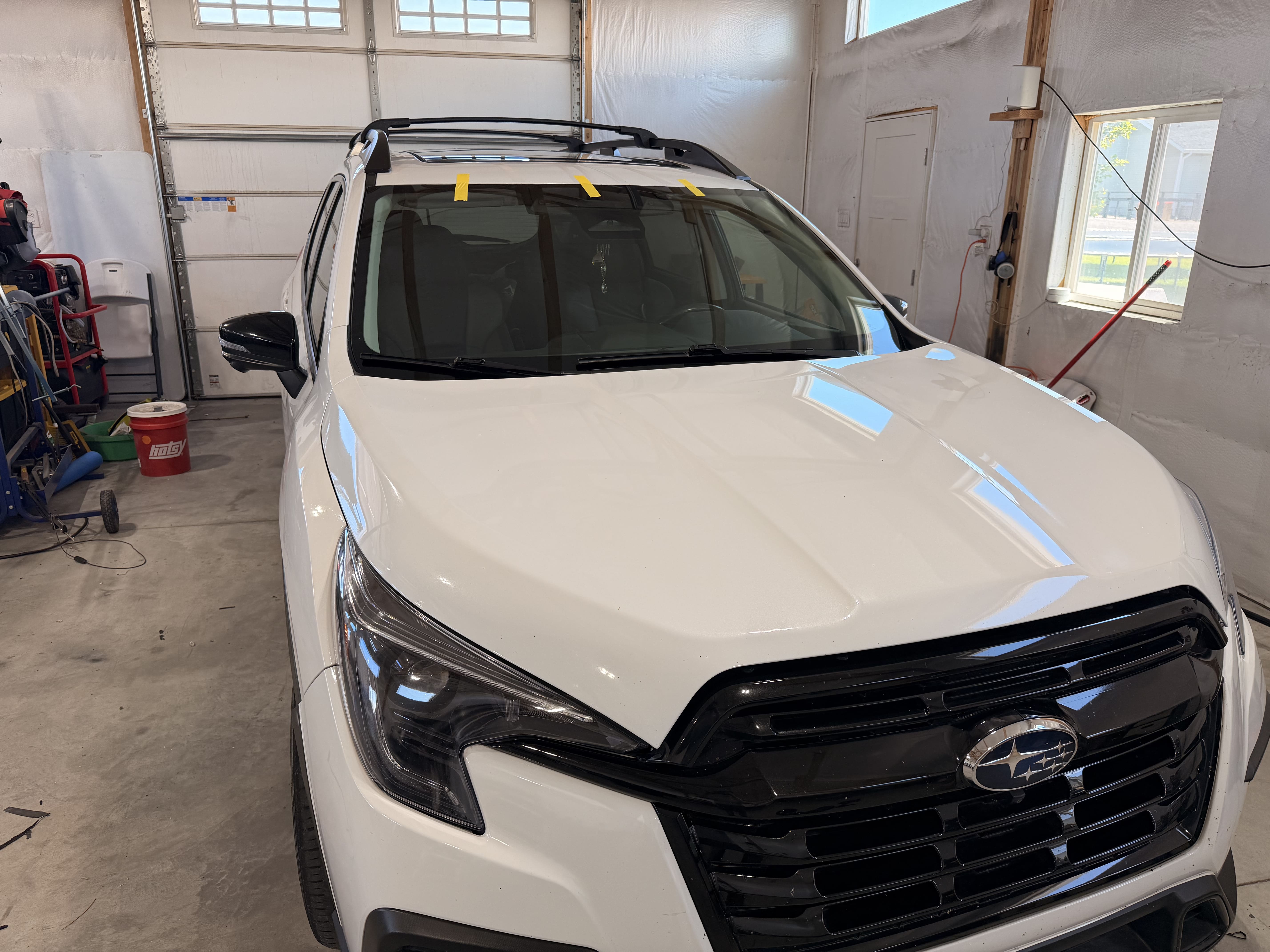 White SUV positioned indoors for windshield service