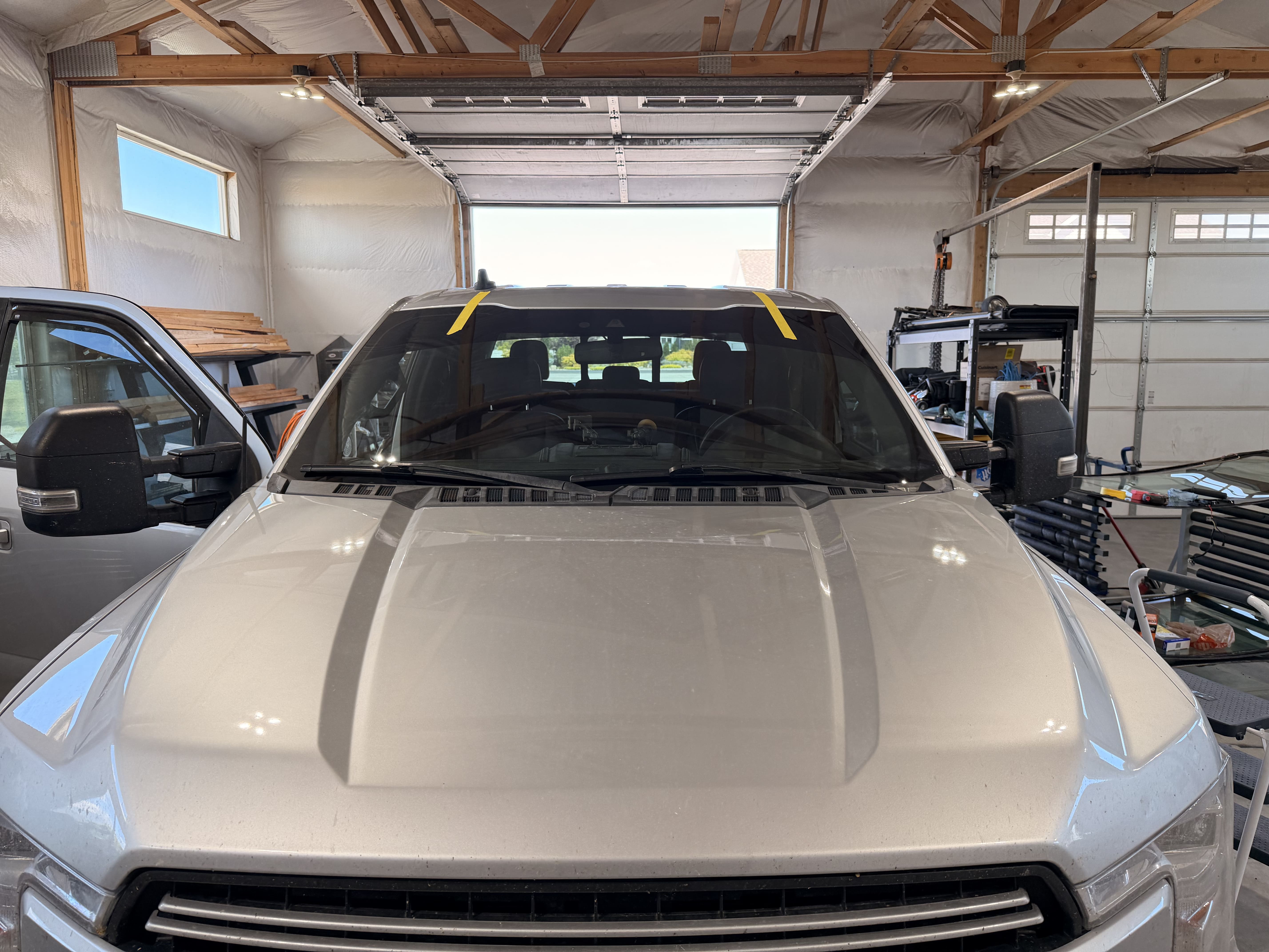 Pickup truck prepared for windshield glass service in a workshop